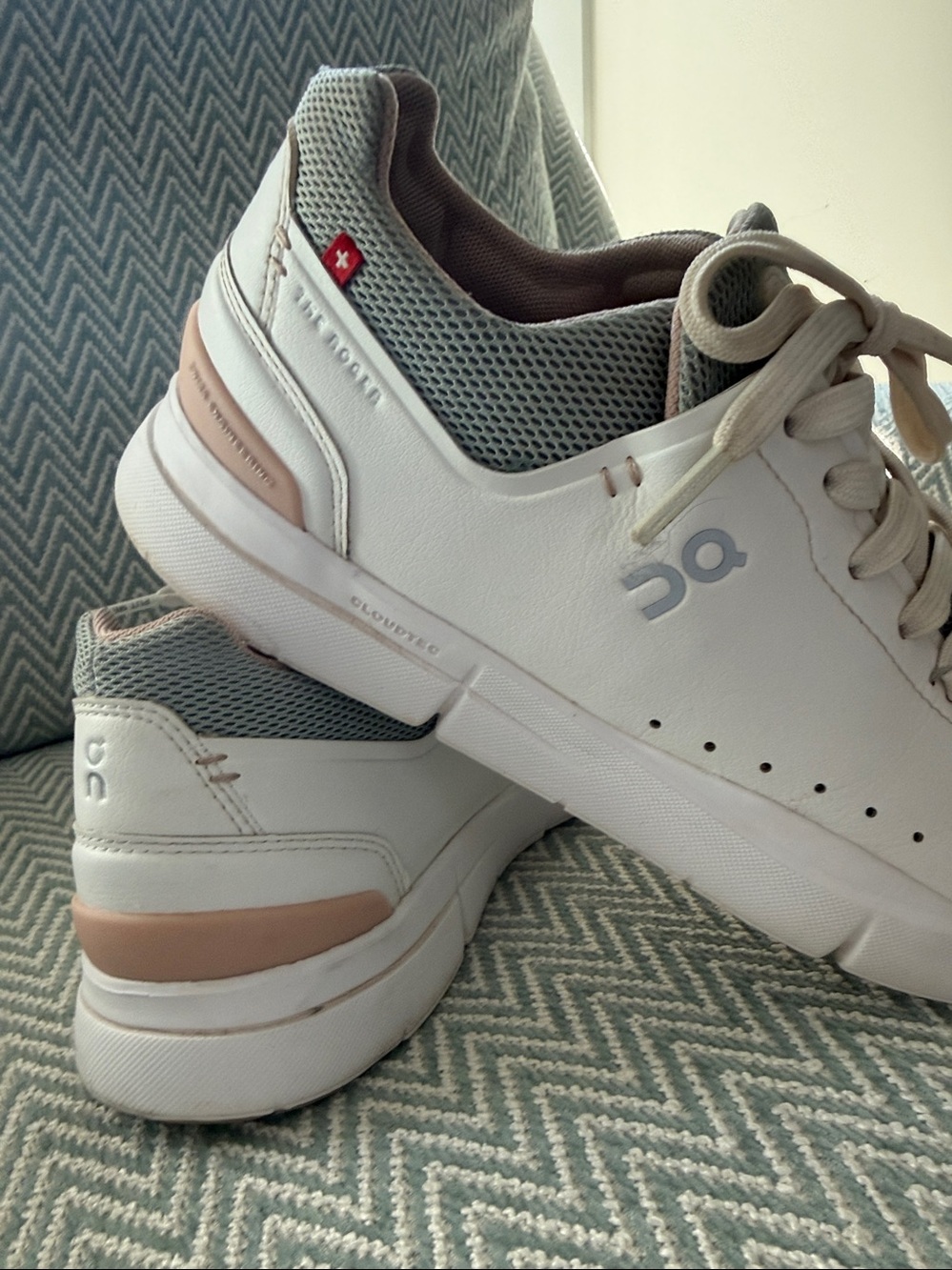On Running Women's White Sneakers with Light Pink Lining and green trim.